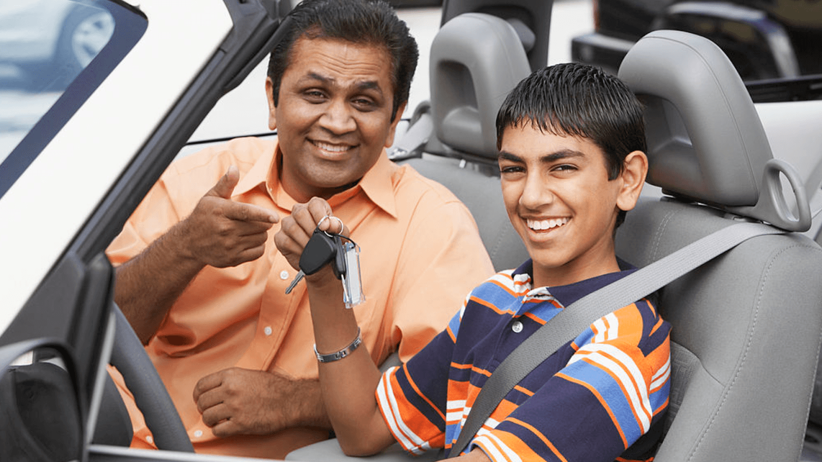 a father and son taking driving lessons