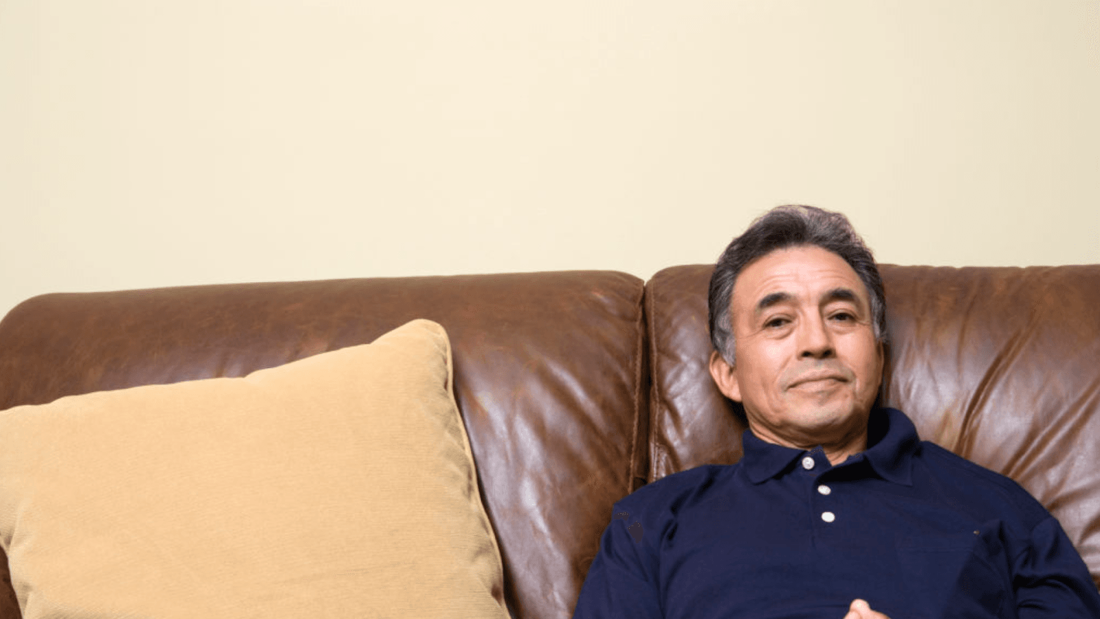 A man in his midlife years sitting on a couch